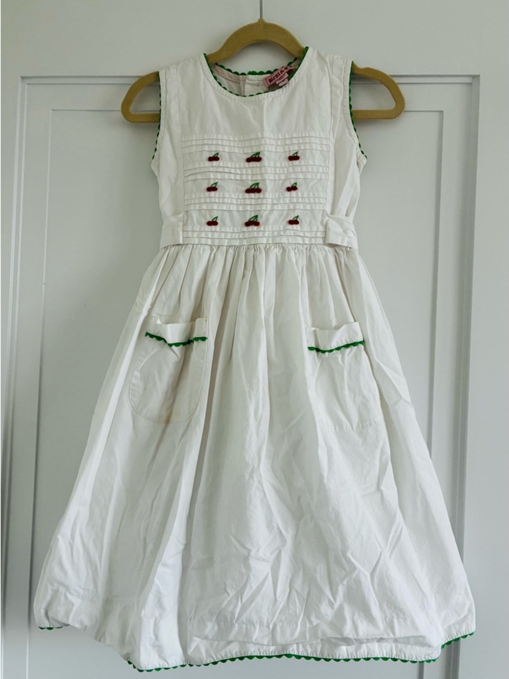 White Sleeveless Girls' Dress with Cherry Embroidery and Green Trim
